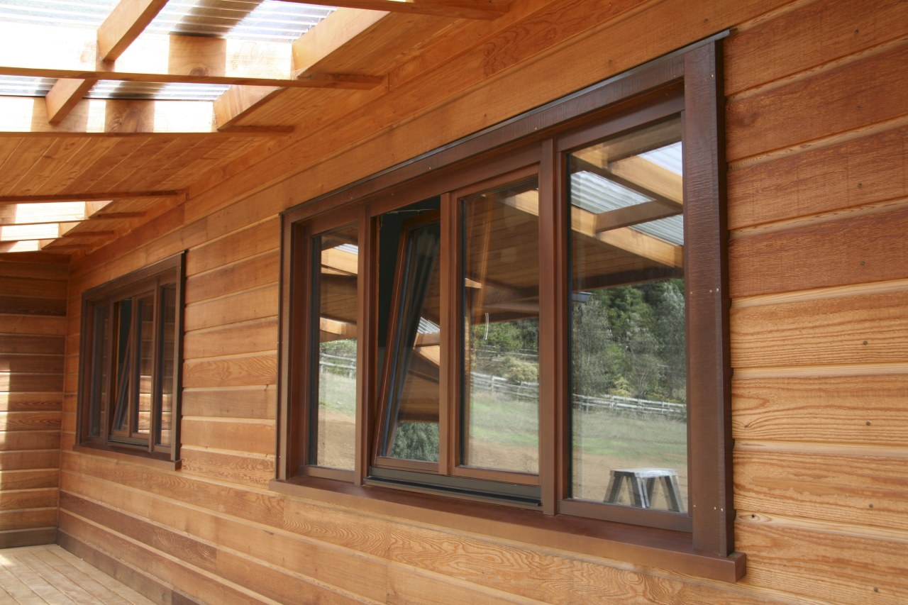 View of windows set into timber joinery by beam, door, facade, home, house, log cabin, lumber, real estate, siding, wall, window, wood, wood stain, brown, orange