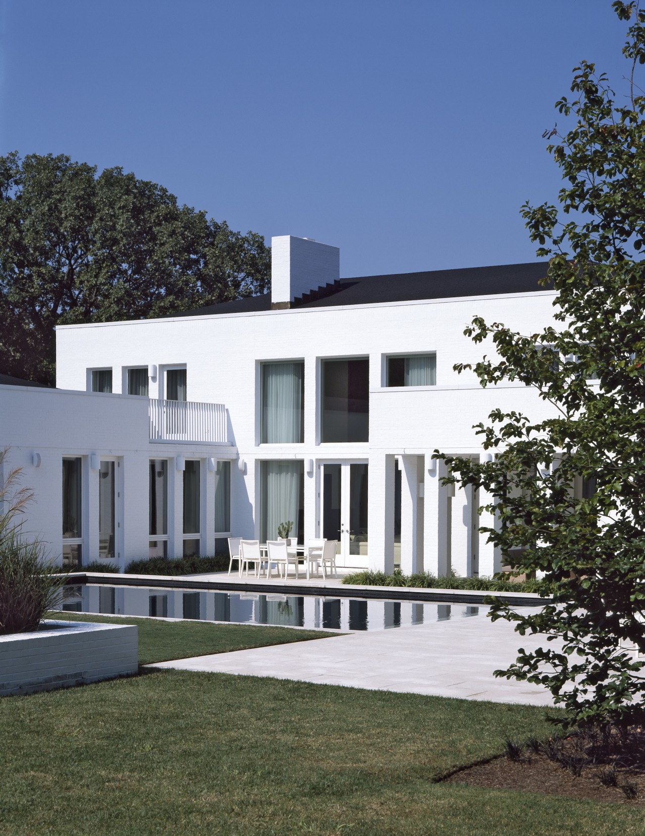 Exterior view of the poolside area architecture, building, condominium, cottage, elevation, estate, facade, home, house, property, real estate, residential area, villa, blue