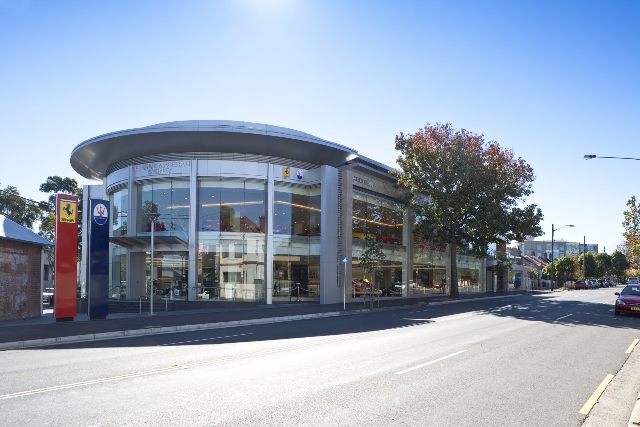 Exterior view of Ferrari Showroom architecture, building, city, commercial building, corporate headquarters, downtown, facade, metropolitan area, mixed use, neighbourhood, real estate, residential area, sky, white, teal