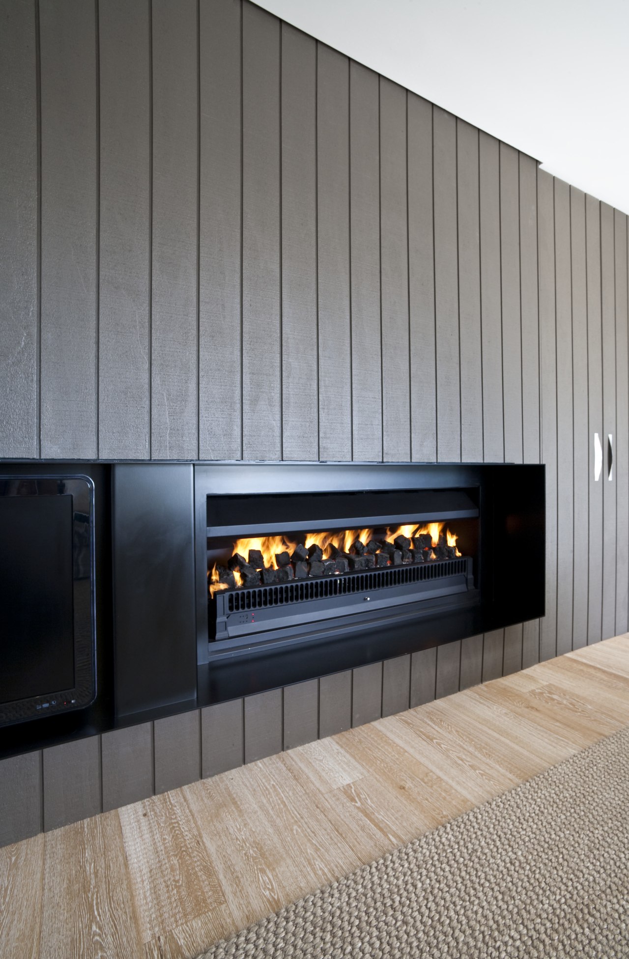 View of a living area which features a fireplace, hearth, gray