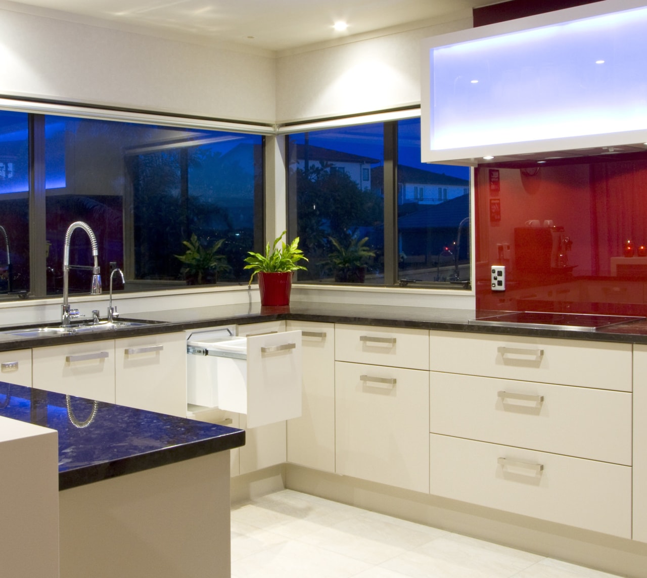 View of a kitchen which features a hideaway cabinetry, countertop, interior design, kitchen, white