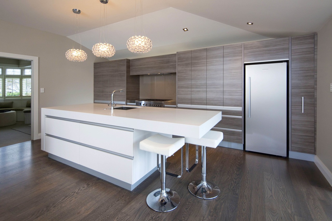 View of a kitchen which features white CeasarStone architecture, cabinetry, countertop, floor, flooring, hardwood, interior design, kitchen, laminate flooring, real estate, room, wall, window, wood, wood flooring, gray