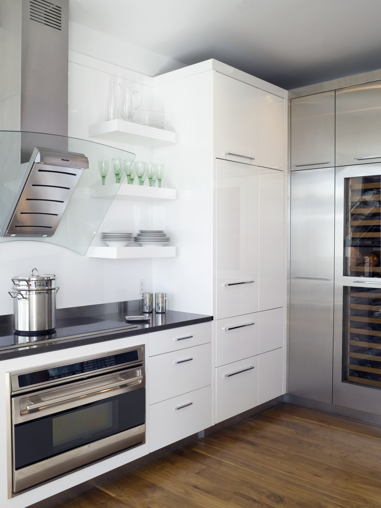 View of contemporary apartment kitchen which features timber cabinetry, countertop, cuisine classique, floor, home appliance, interior design, kitchen, kitchen appliance, kitchen stove, major appliance, refrigerator, room, gray, white