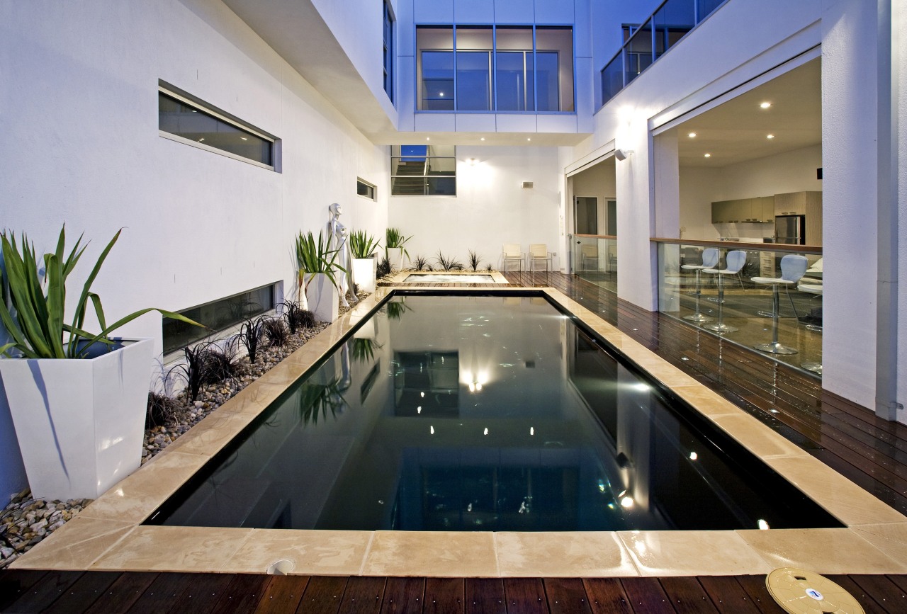 Evening view of the poolside area apartment, condominium, estate, home, house, interior design, property, real estate, swimming pool, gray