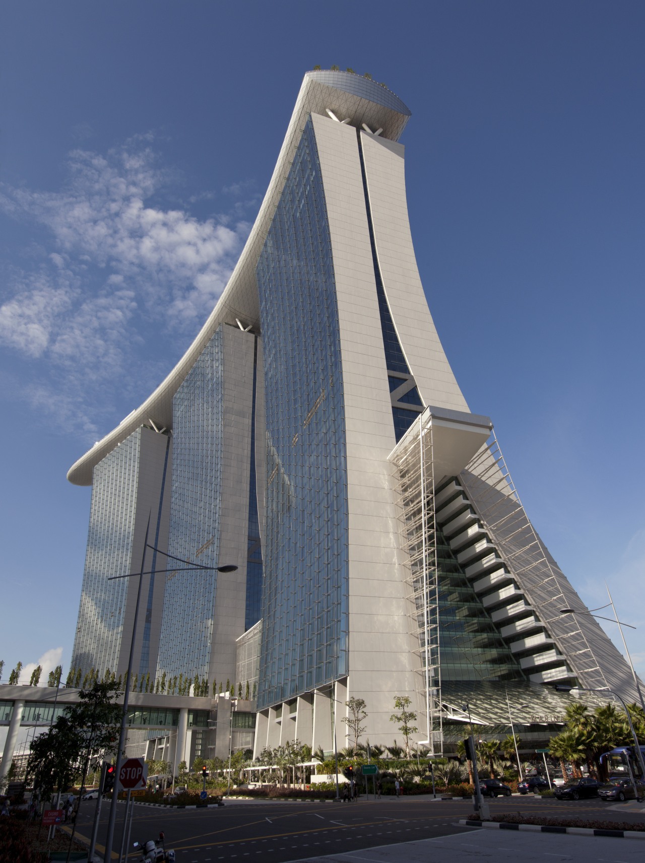 Concrete features prominently in the design of the architecture, building, corporate headquarters, daytime, fixed link, headquarters, landmark, metropolis, metropolitan area, sky, skyscraper, tower, tower block, blue, gray