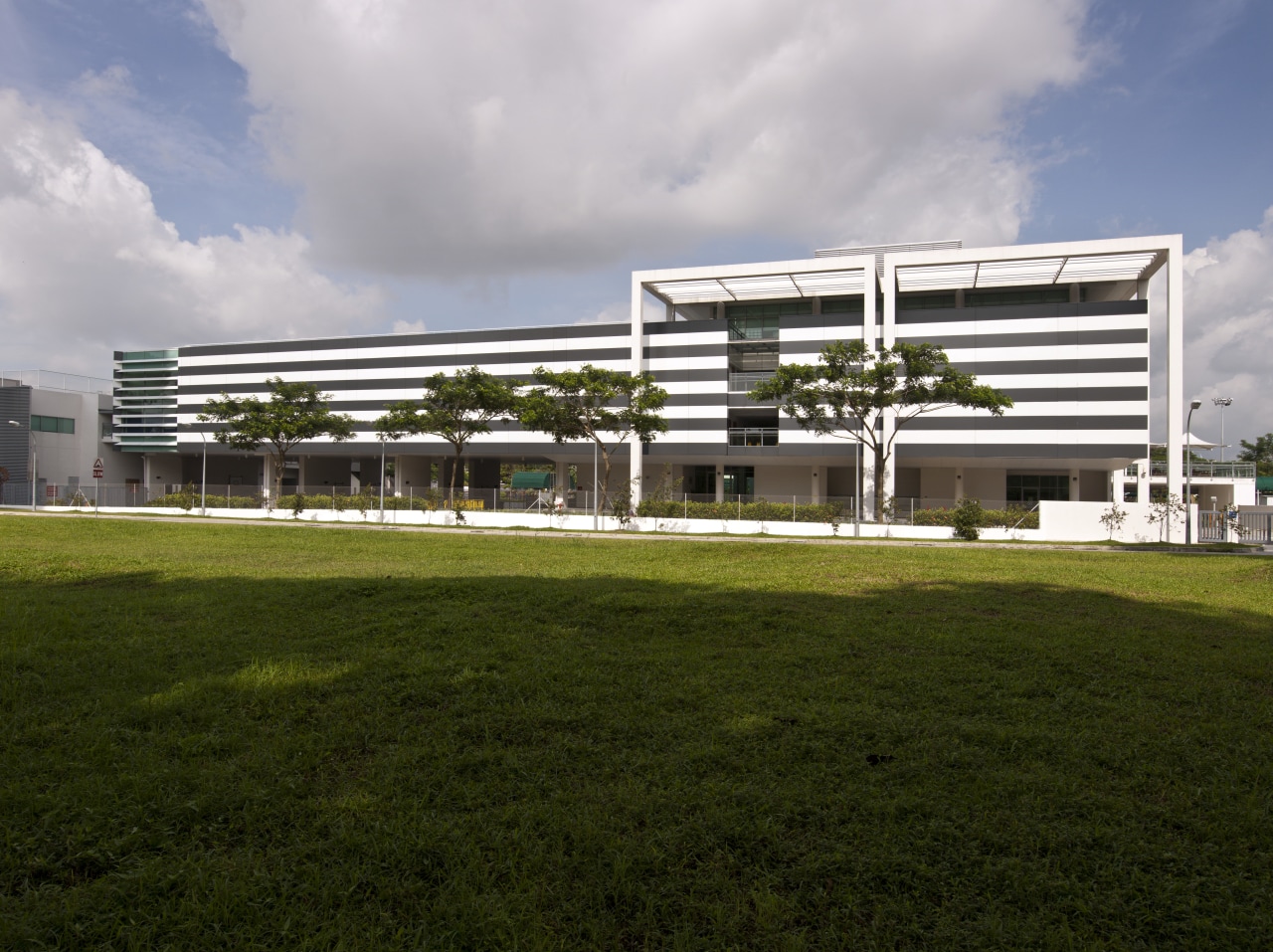 Exterior view from the fields architecture, building, corporate headquarters, facade, grass, headquarters, house, sky, structure, brown, gray