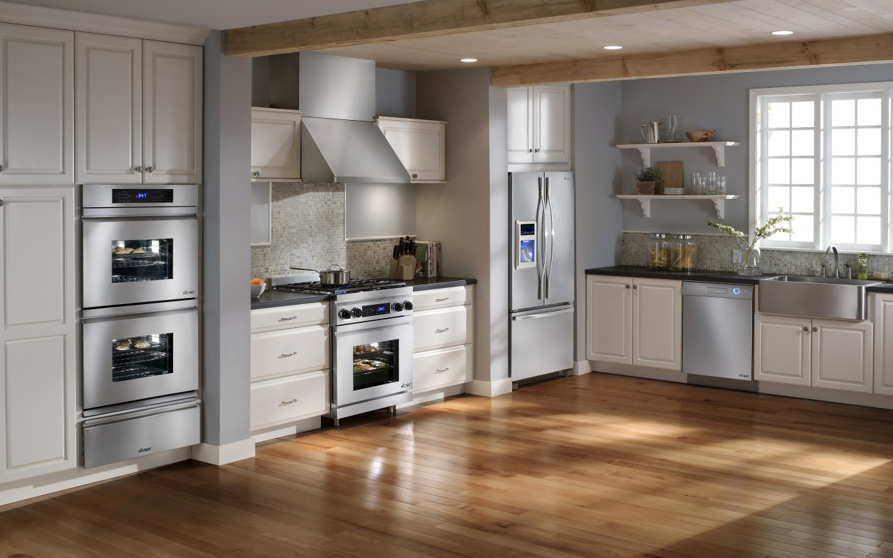 View of a family kitchen which features Dacor cabinetry, countertop, cuisine classique, floor, flooring, hardwood, home appliance, interior design, kitchen, laminate flooring, room, wood flooring, gray, brown