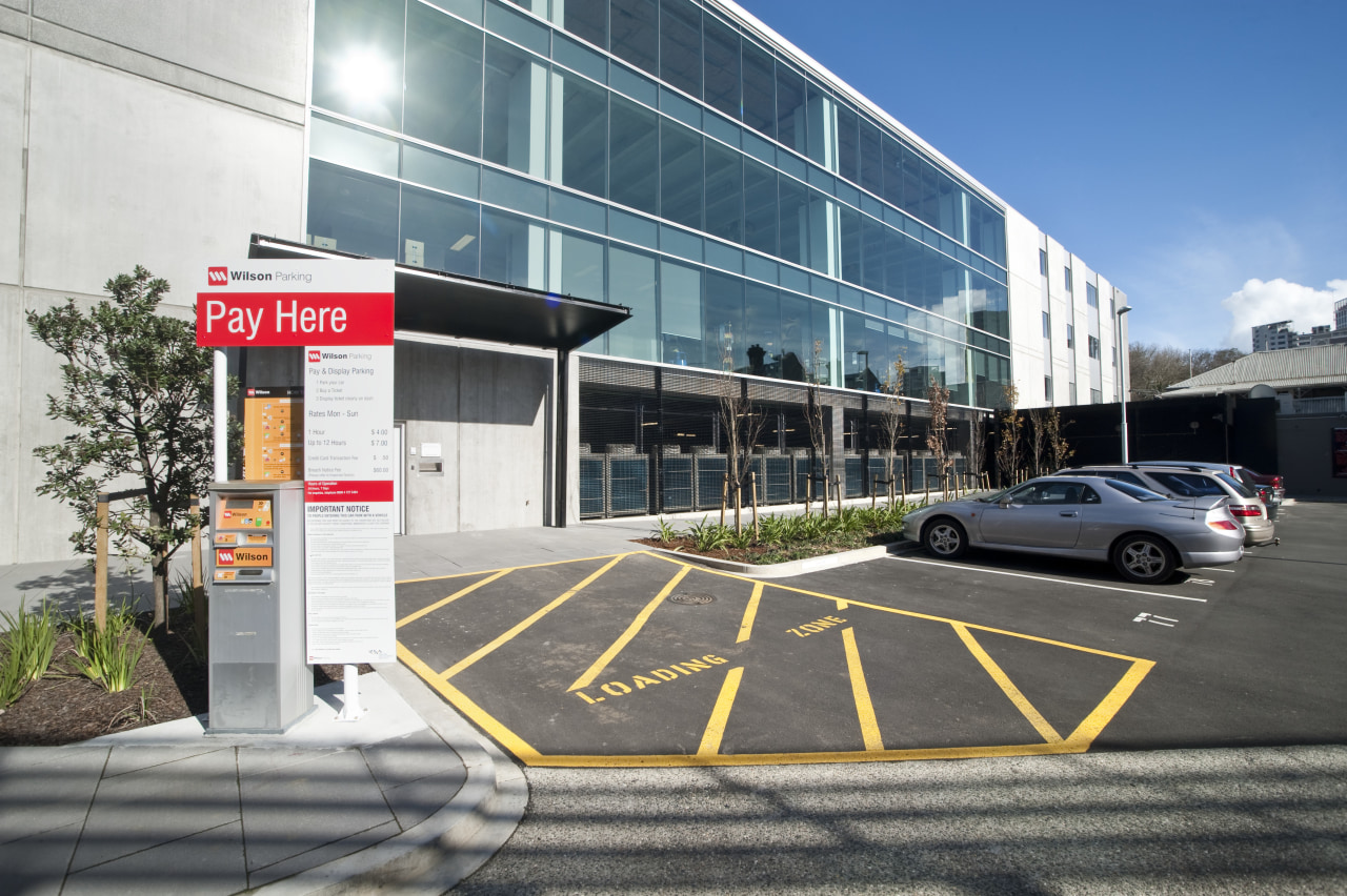 Exterior view of the carpark outside the office architecture, building, car, car dealership, commercial building, corporate headquarters, facade, family car, luxury vehicle, metropolitan area, mixed use, motor vehicle, parking, parking lot, real estate, vehicle, white