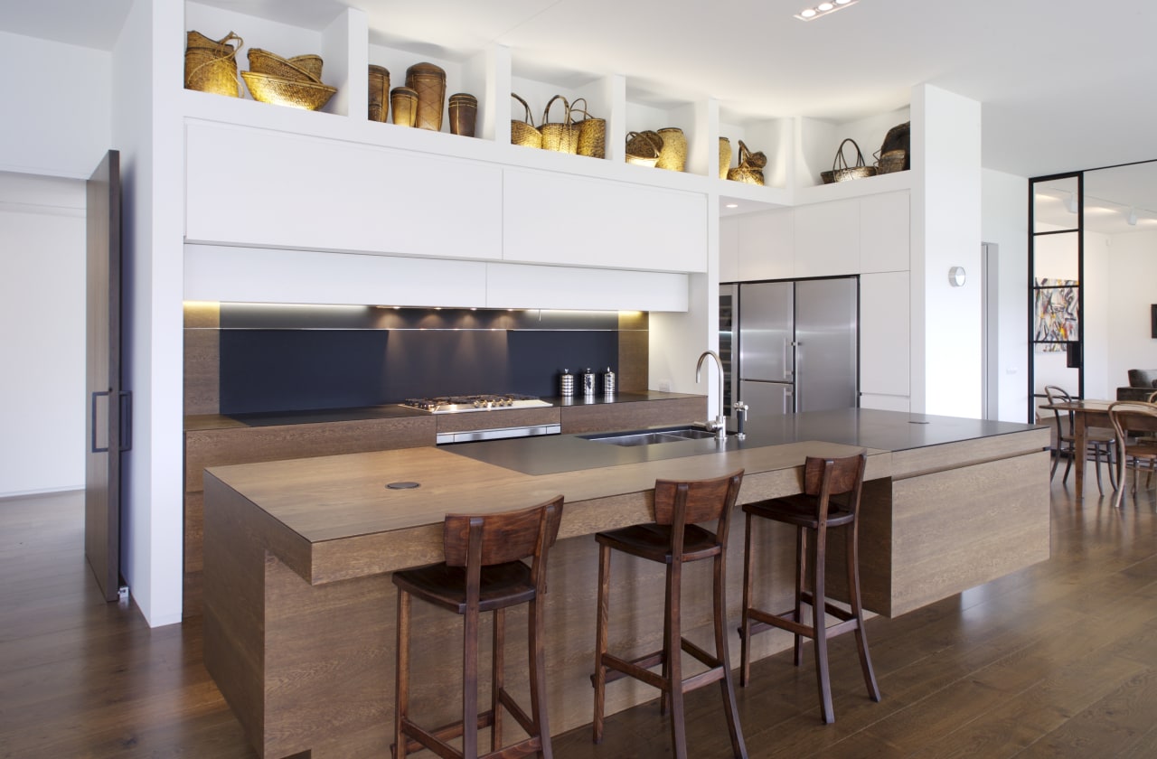 View of contemporary kitchen with wooden island and cabinetry, countertop, floor, flooring, furniture, hardwood, interior design, kitchen, laminate flooring, real estate, room, table, wood, wood flooring, white