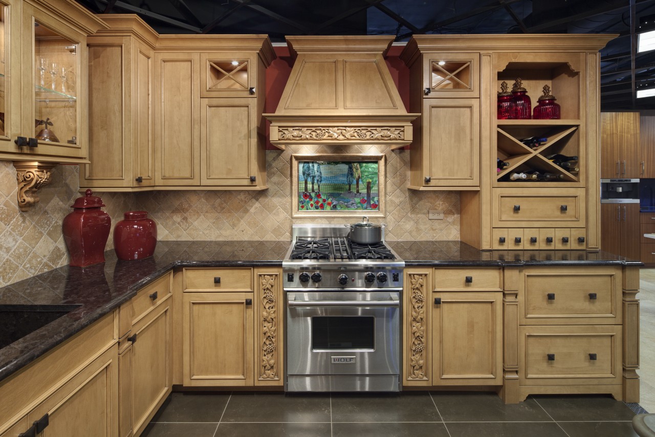 View of a traditional styled kitchen which features cabinetry, countertop, cuisine classique, flooring, hardwood, interior design, kitchen, room, under cabinet lighting, wood flooring, brown, orange