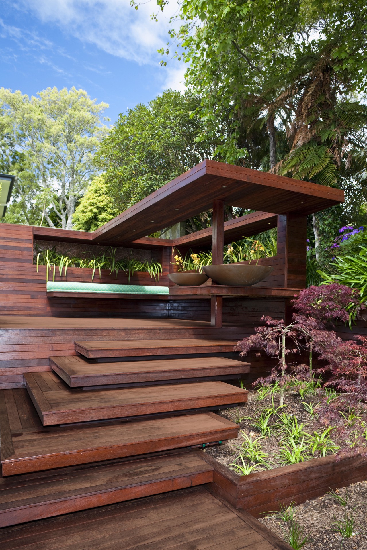 View of timber outdoor seating area with large backyard, home, house, outdoor structure, plant, tree, wood, red