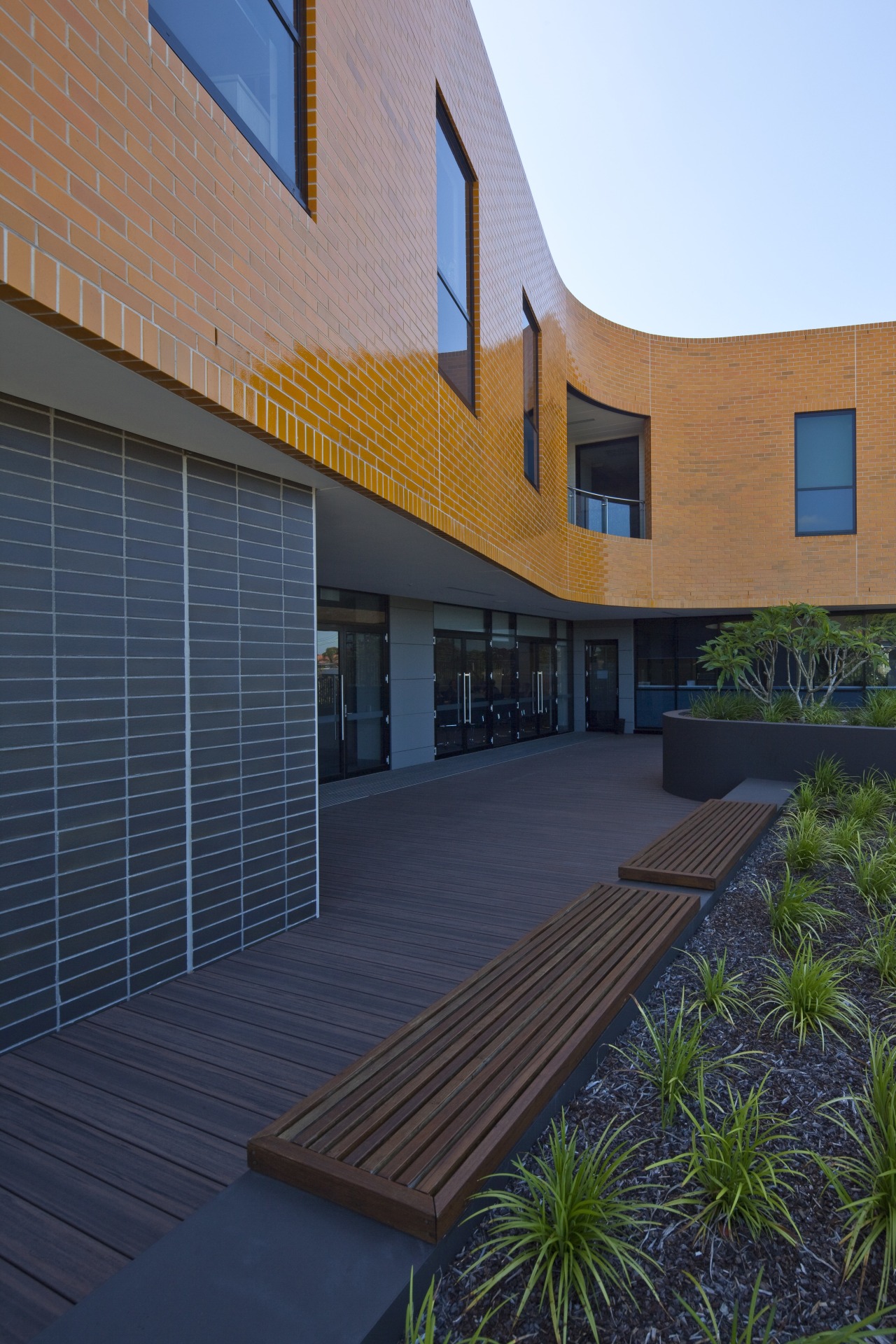 Exterior view of the Poche Centre which was apartment, architecture, building, elevation, estate, facade, home, house, property, real estate, residential area, siding, sky, window, blue