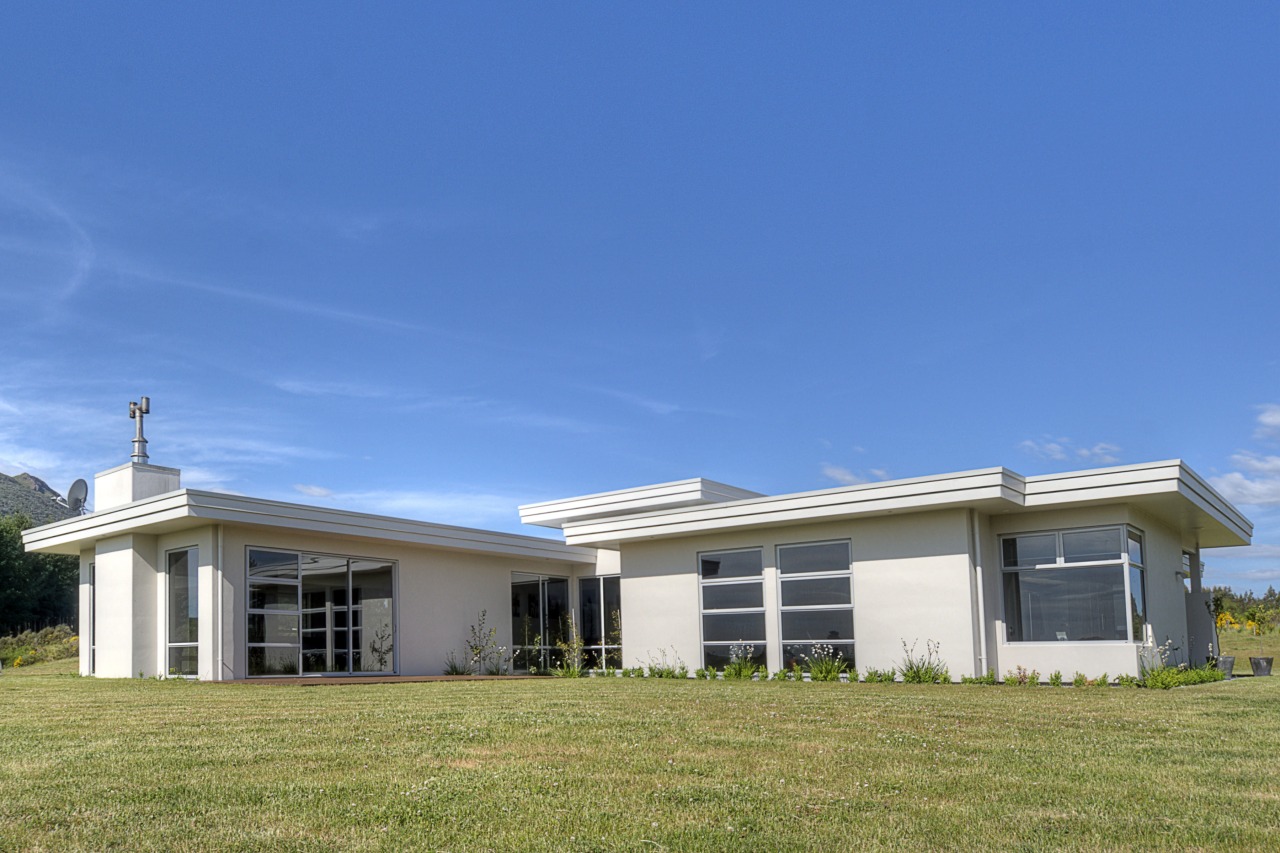 View of a house which is clad in cloud, cottage, elevation, estate, facade, farmhouse, grass, home, house, property, real estate, residential area, roof, rural area, sky, blue