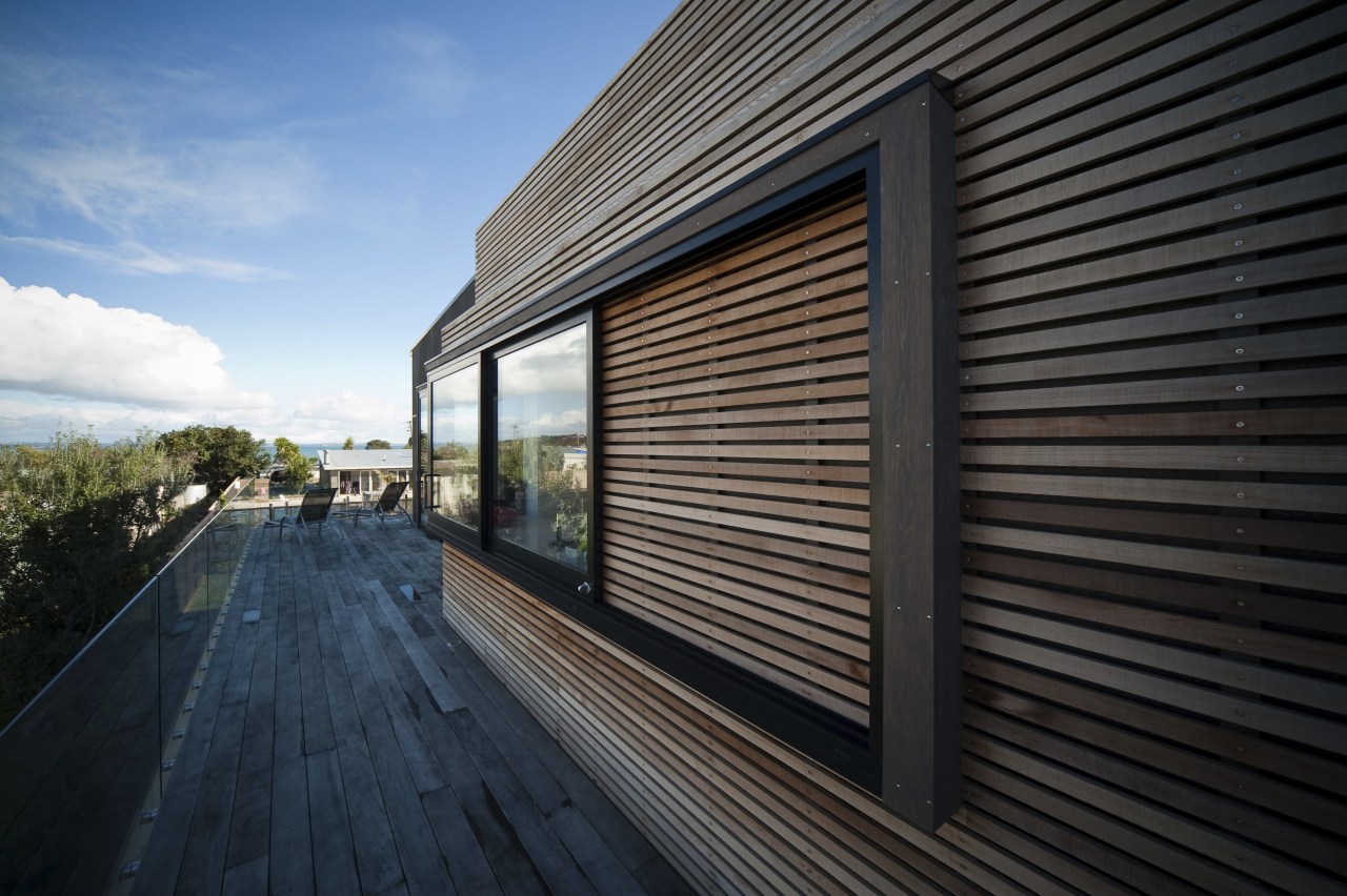 View of the Lite-House on Waiheke Island, a architecture, building, daylighting, facade, home, house, property, real estate, residential area, siding, sky, window, wood, black