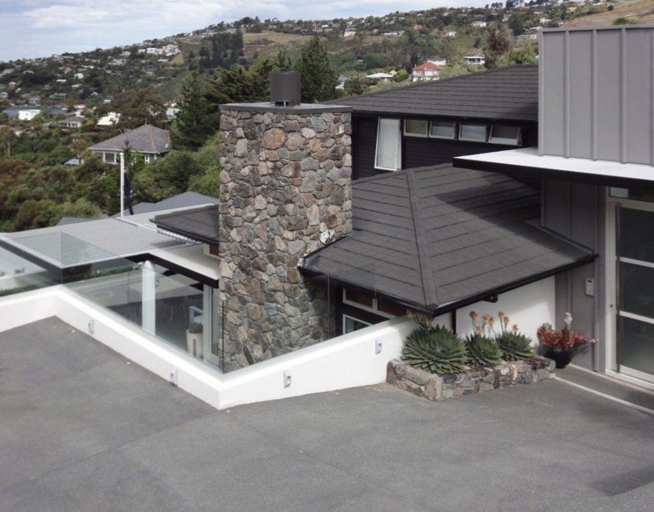 View of DJ Hewitt house built on a architecture, facade, house, outdoor structure, property, real estate, roof, siding, gray