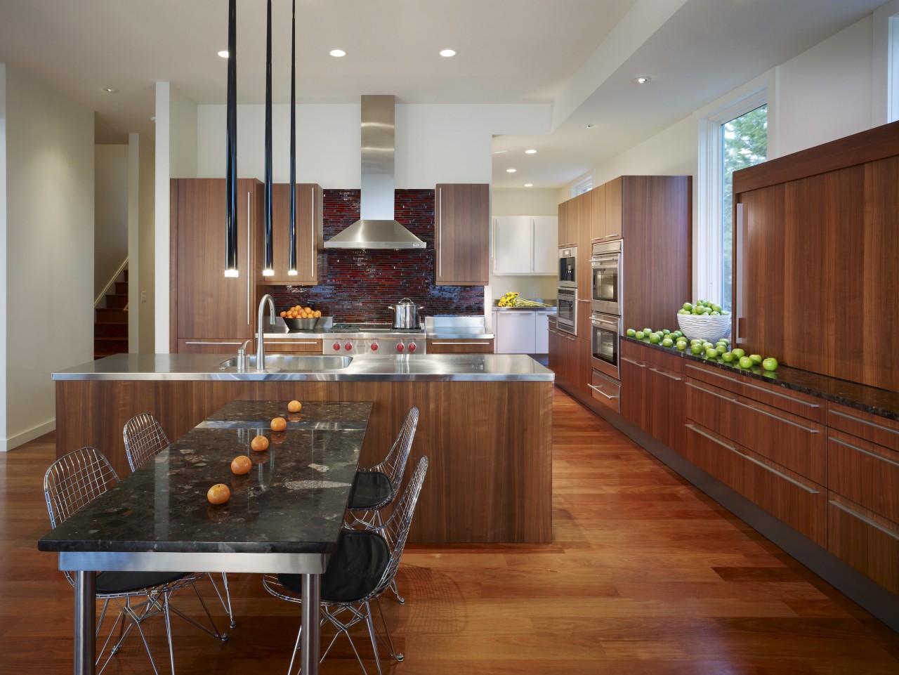 View of a kitchen which combines commerical touches cabinetry, countertop, dining room, flooring, hardwood, interior design, kitchen, real estate, room, wood flooring, brown, gray