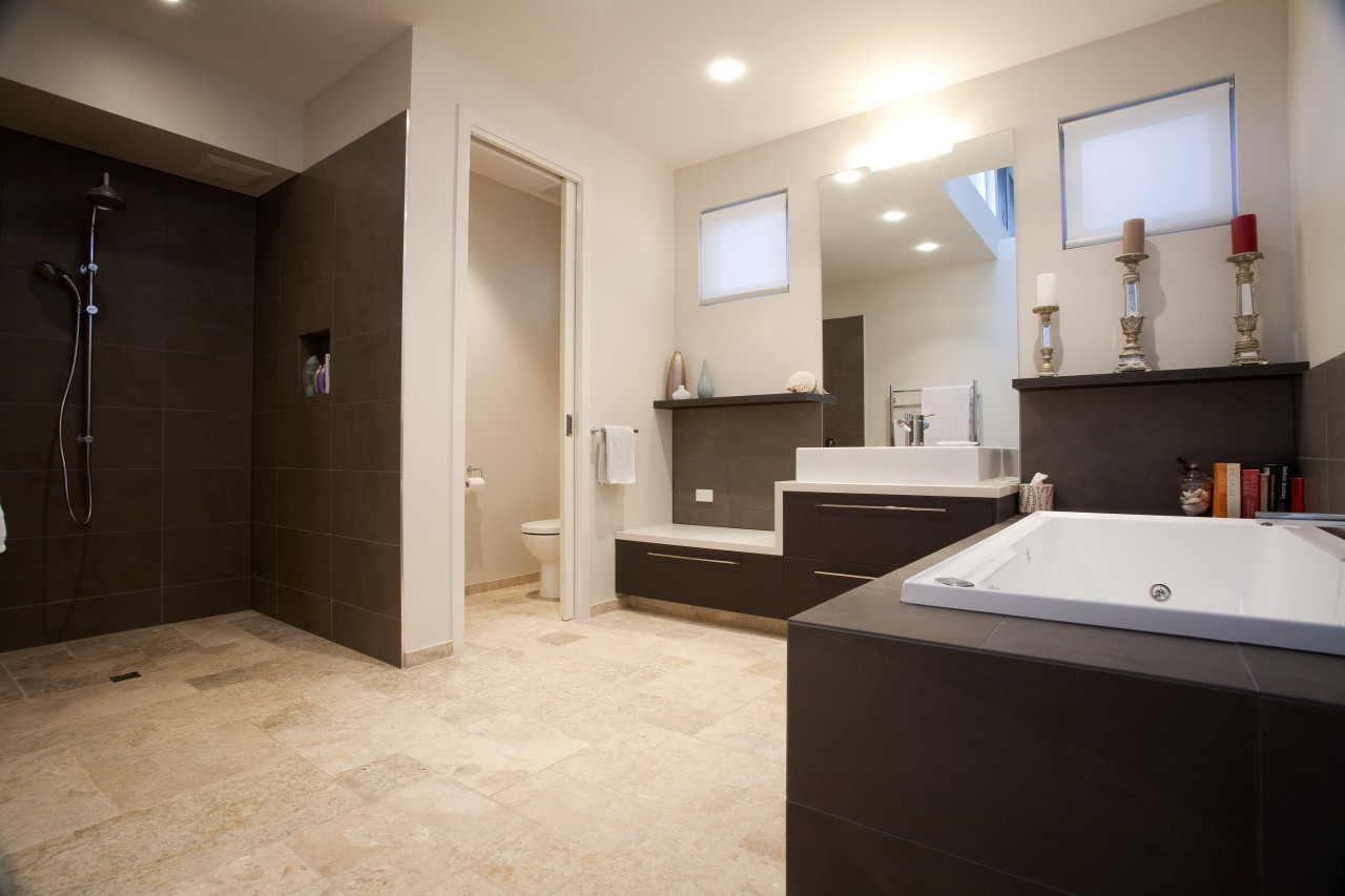 View of contemporary home with dark cabinetry, wooden bathroom, estate, floor, flooring, home, interior design, property, real estate, room, tile, gray, black