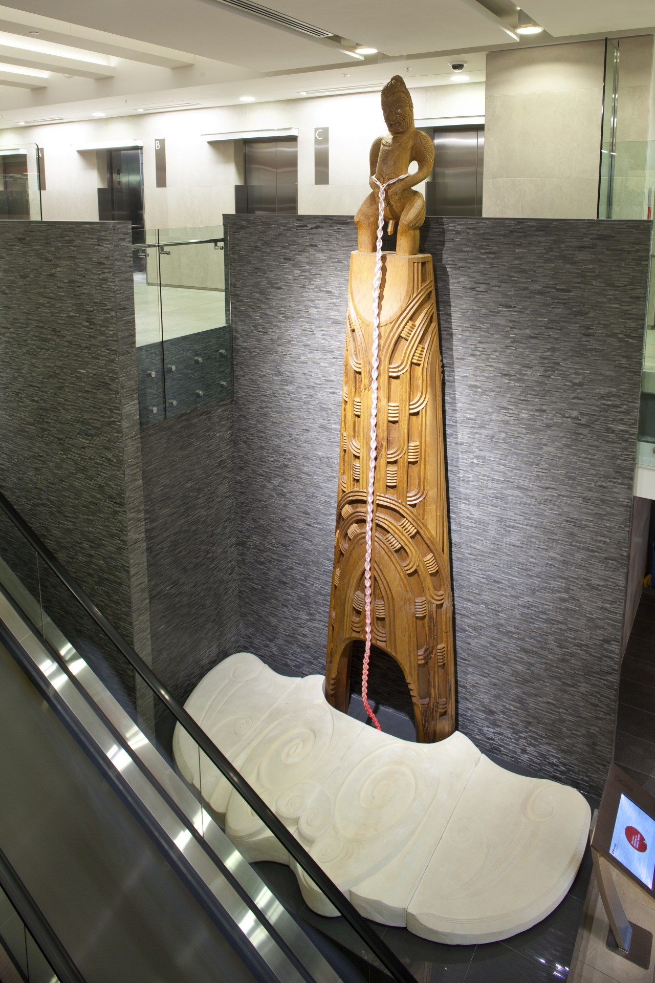 View of Maori carving in the entrance foyer flooring, interior design, gray, black