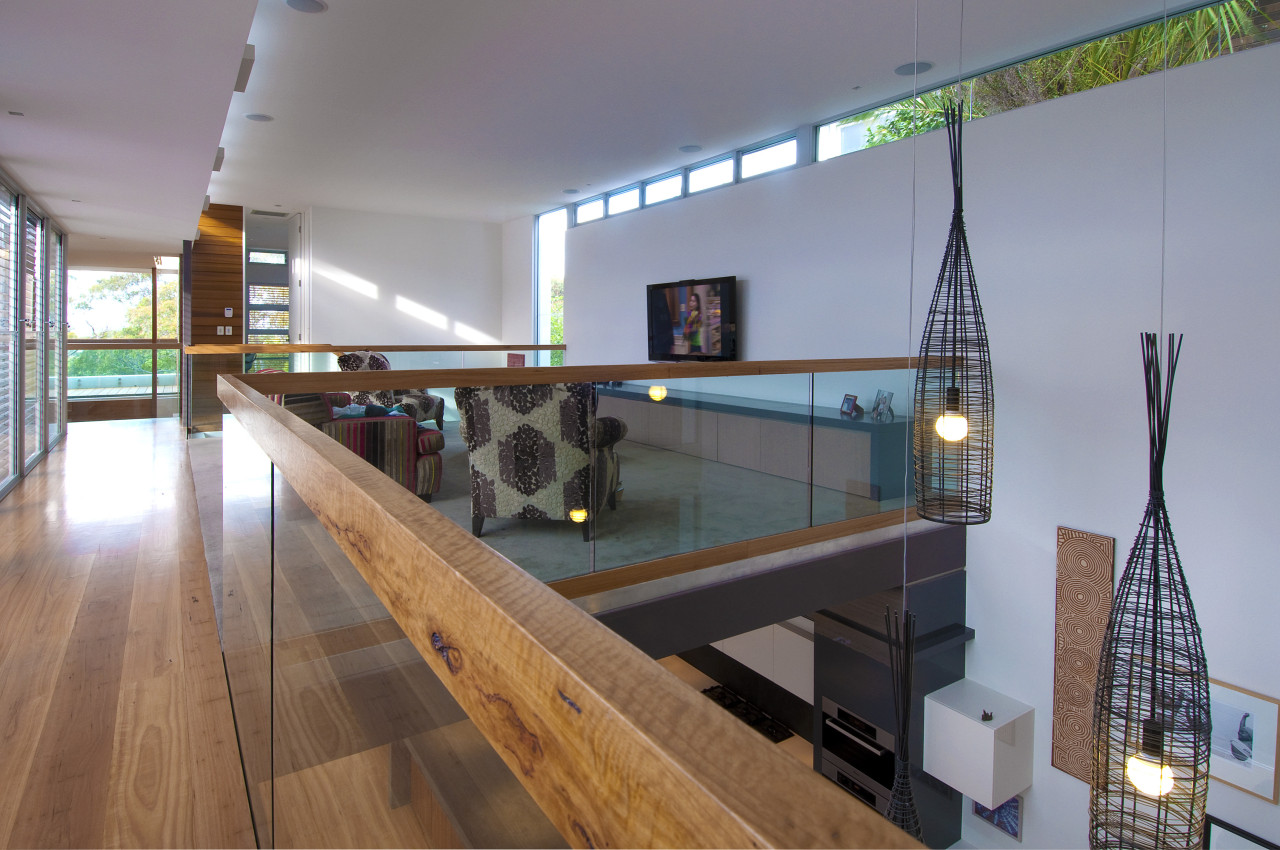 View of mezzanine area with wooden floor and glass, handrail, interior design, gray
