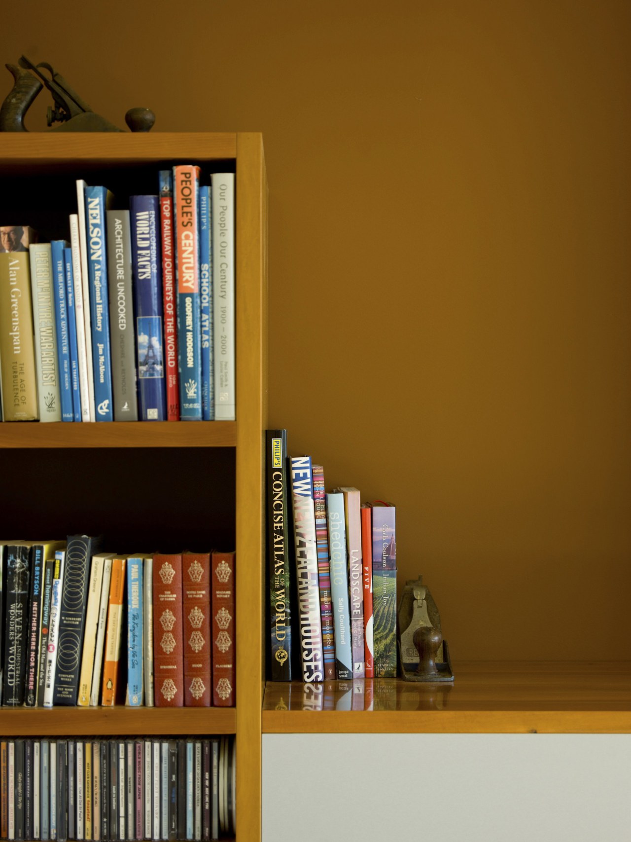 View of yellow wall, painted using Resene paints. book, bookcase, bookselling, furniture, library, public library, shelf, shelving, brown
