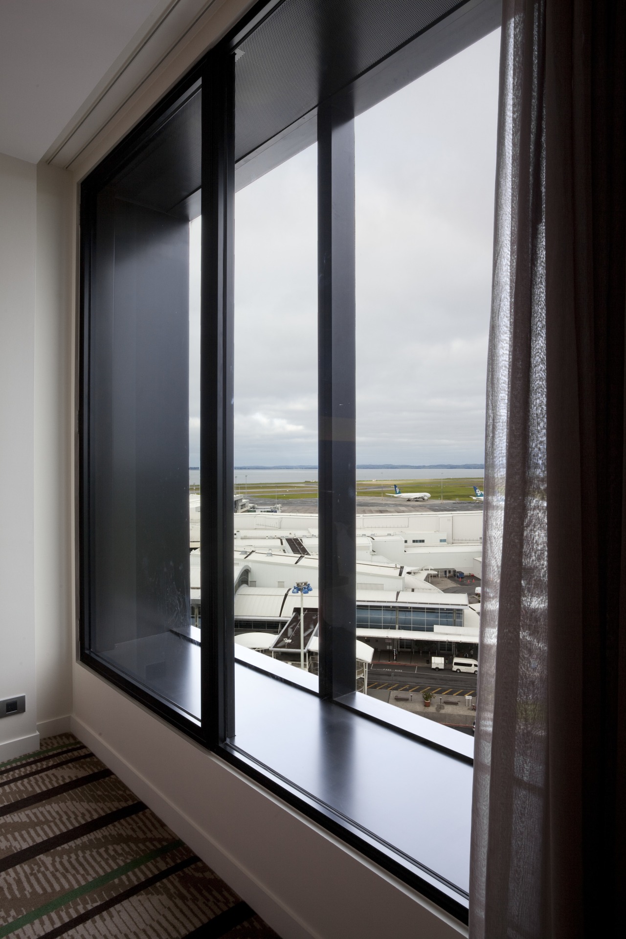 View from suite at the Novotel Auckland Airport door, glass, interior design, window, black, gray