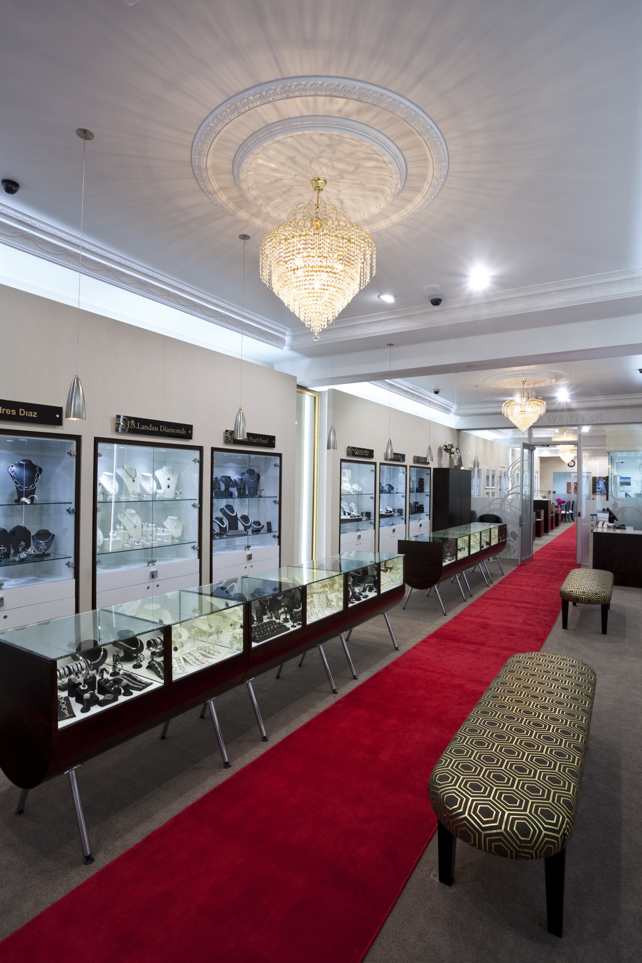 View of the Anna Webster Jeweler boutique.Features repeating ceiling, interior design, lobby, table, gray