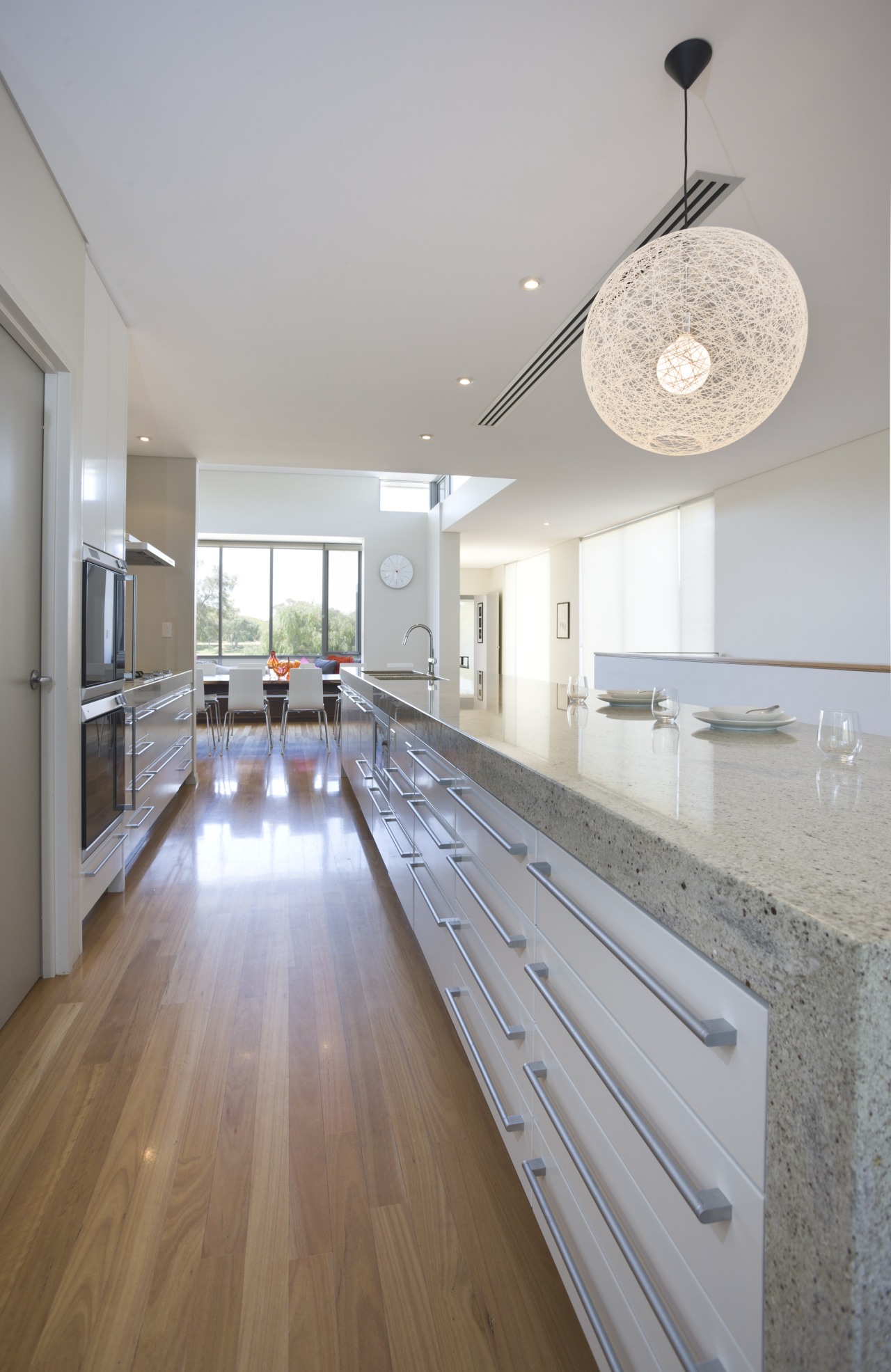 This 12ft-long island features a Bianco Romano granite architecture, ceiling, countertop, daylighting, floor, flooring, hardwood, home, house, interior design, kitchen, laminate flooring, real estate, room, wood, wood flooring, gray