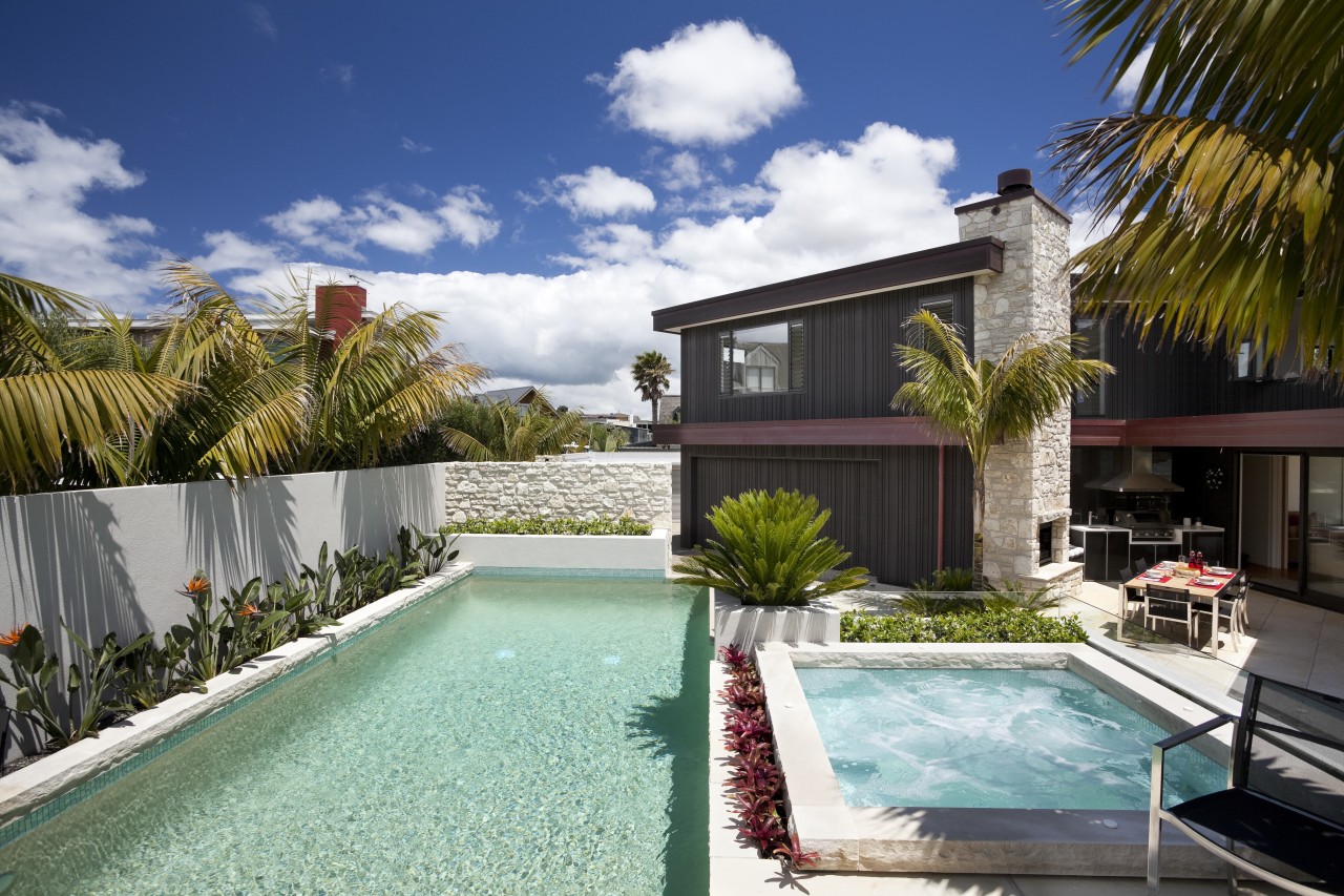 View of pool area of contemporary home. arecales, backyard, estate, home, house, leisure, palm tree, property, real estate, residential area, resort, swimming pool, villa