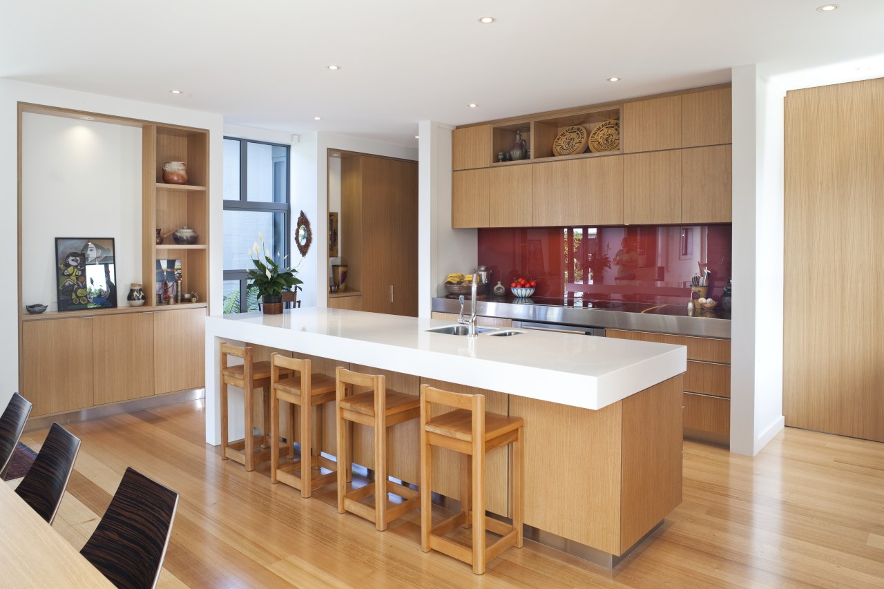 View of kitchen with wooden flooring, white bench cabinetry, countertop, floor, flooring, hardwood, interior design, kitchen, real estate, room, wood, wood flooring, white, orange