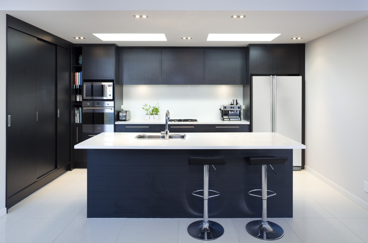 View of kitchen with dark toned cabinets and cabinetry, countertop, interior design, kitchen, product design, black, gray, white