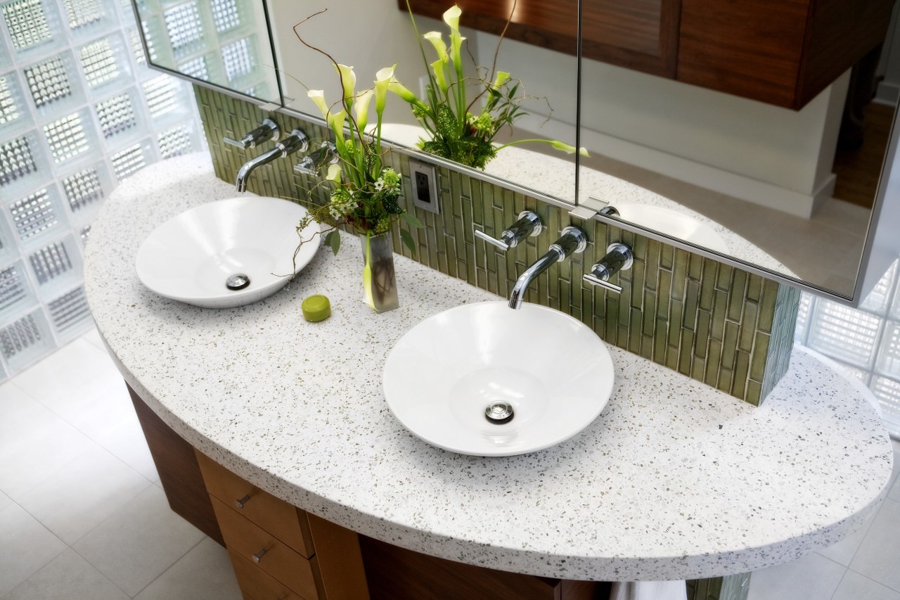 Walnut cabinetry lines the entry to this glass bathroom, ceramic, countertop, interior design, plumbing fixture, product design, sink, table, tap, tile, white