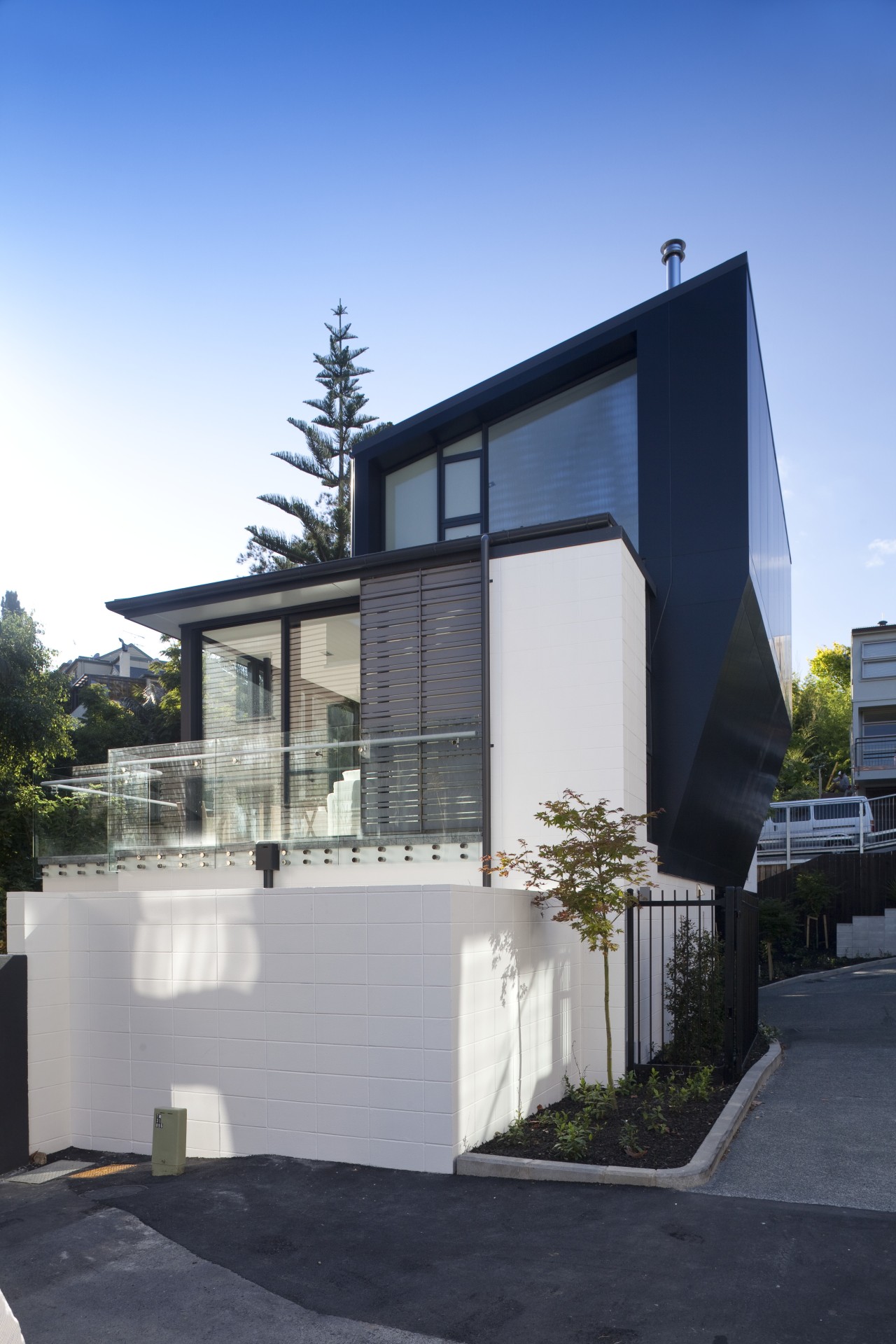 View of exterior with white and wall walls. architecture, building, elevation, facade, home, house, property, real estate, residential area