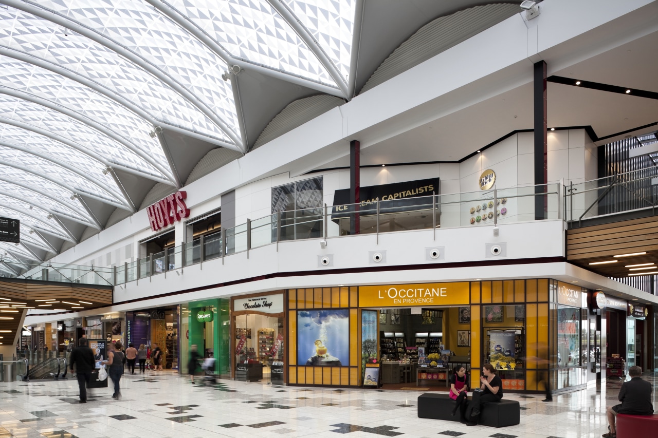 View of interior of mall. building, mixed use, outlet store, retail, shopping mall, white