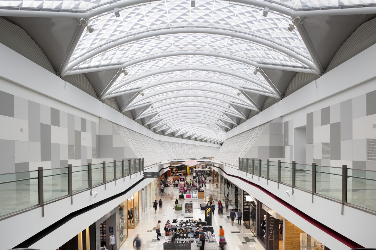 View of light toned interior of mall. architecture, building, daylighting, metropolitan area, mixed use, shopping mall, tourist attraction, white, gray