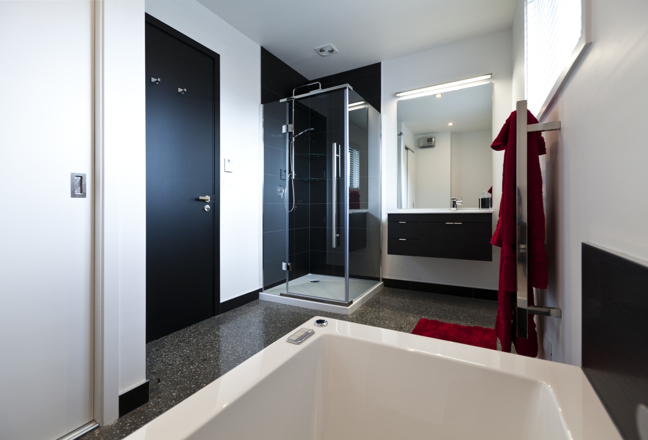 Bathroom with contemporary white tub, black door and bathroom, interior design, real estate, room, gray, white
