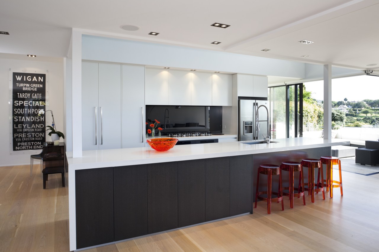 View of contemporary kitchen with wooden flooring, white countertop, house, interior design, kitchen, real estate, gray, white