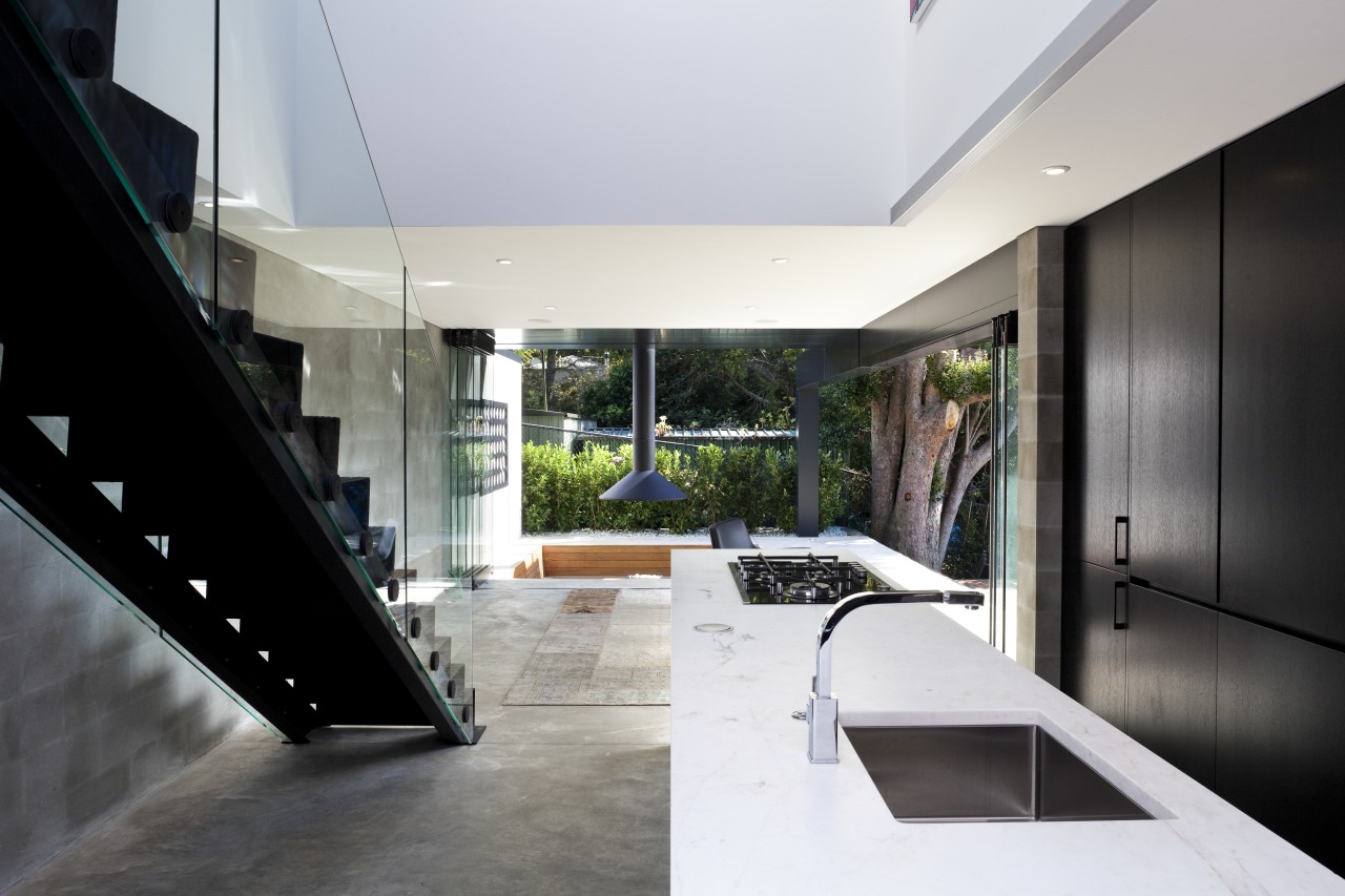 Kitchen near stairs. White countertop, black cabinetry. See architecture, house, interior design, white, black