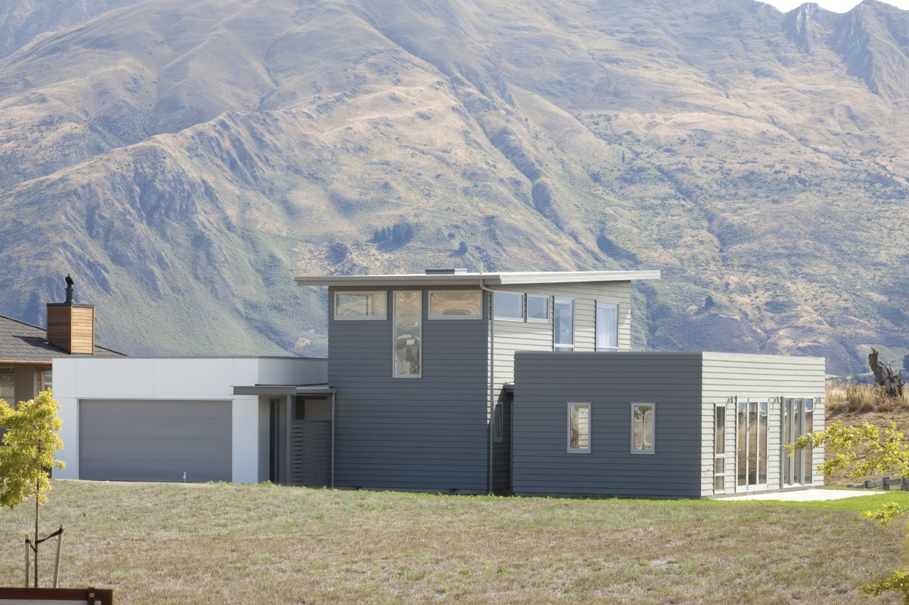 David Reid Homes. Exterior of house in Otago architecture, cottage, elevation, facade, farmhouse, home, house, hut, mountain, property, real estate, roof, sky, gray