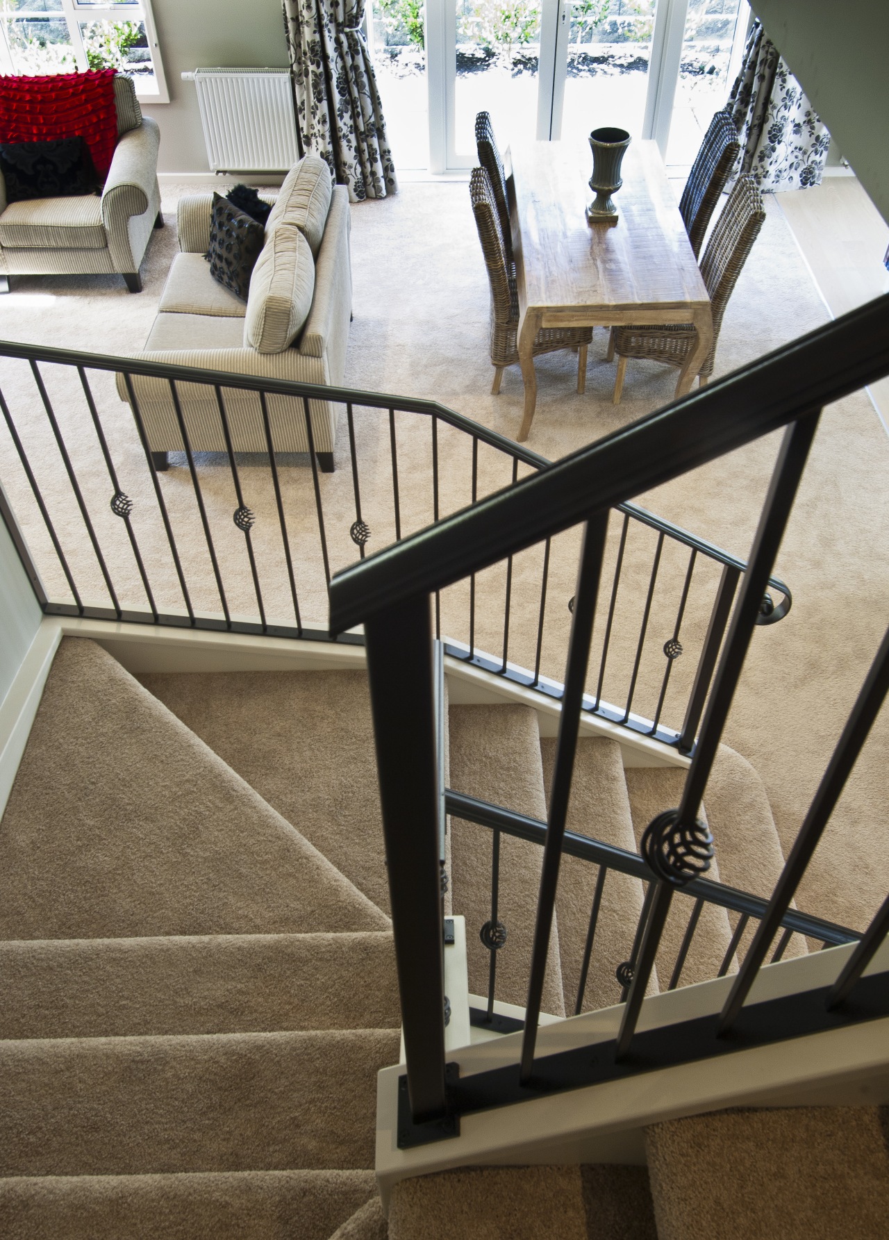 wrought iron banister carpeted stairs leading to lounge baluster, chair, floor, flooring, furniture, handrail, iron, product, stairs, table, brown, white