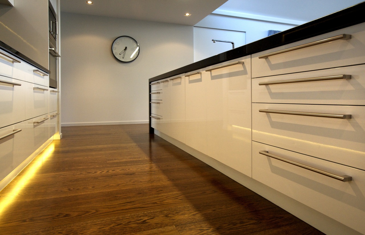 Kitchen design by Kitchen Focus. cabinetry, countertop, floor, flooring, hardwood, interior design, kitchen, laminate flooring, wood, wood flooring, orange, brown