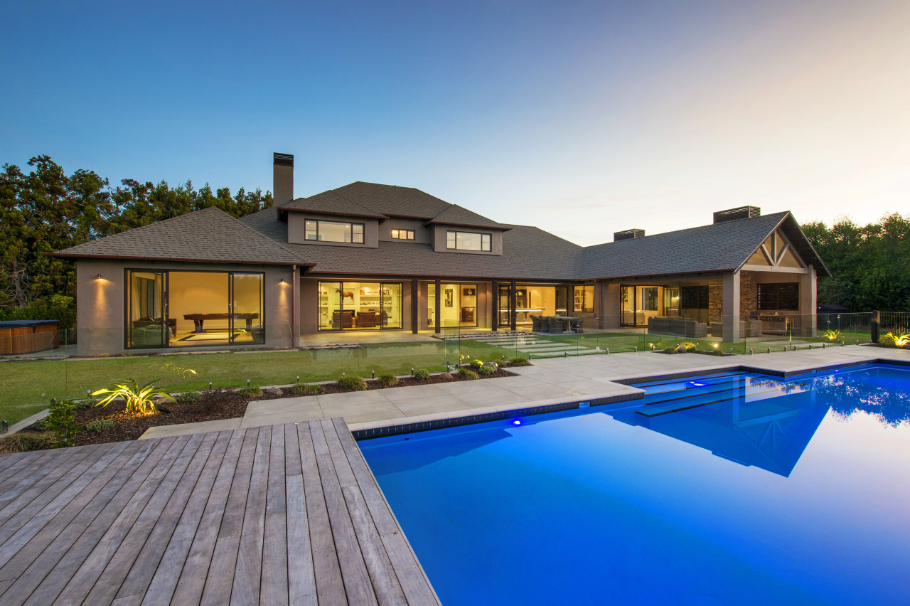 This contemporary, well-balanced masonry home was designed and backyard, cottage, estate, facade, home, house, leisure, mansion, property, real estate, residential area, resort, roof, swimming pool, villa, teal