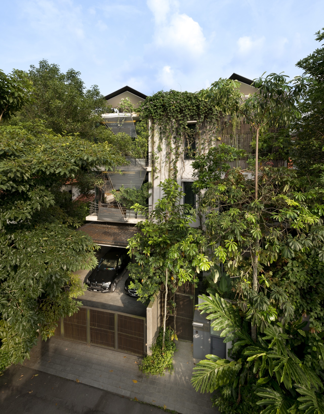 Almost hidden from sight, this city residence sits estate, garden, home, house, outdoor structure, plant, property, real estate, tree, vegetation, brown