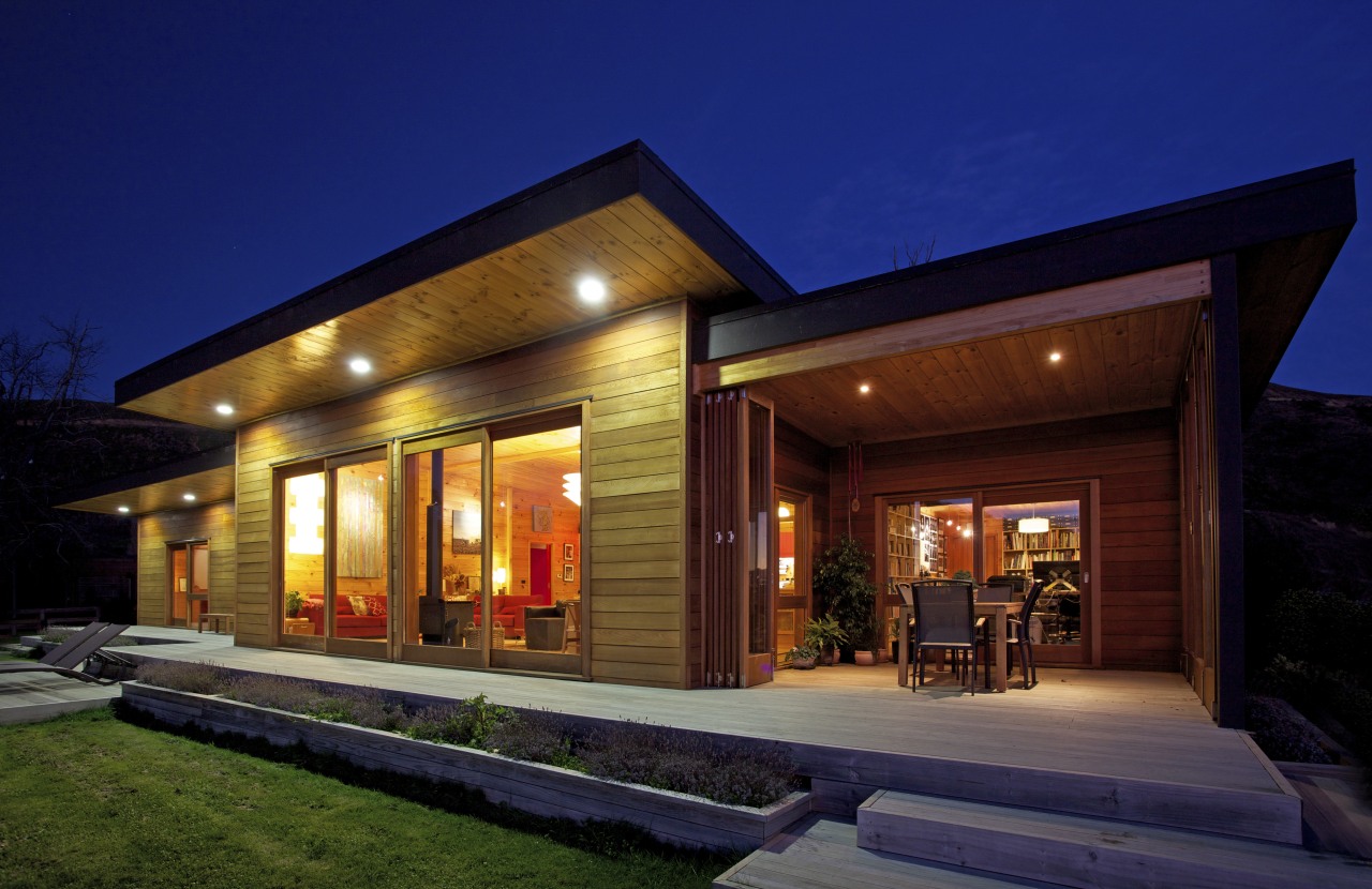 Cedar cladding wraps the exterior of this Lockwood architecture, estate, facade, home, house, lighting, night, property, real estate, residential area, sky, blue