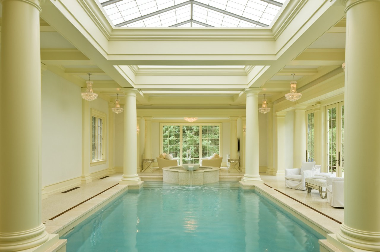 This pavilion-style indoor pool is flooded with natural ceiling, column, daylighting, estate, home, interior design, lobby, property, real estate, structure, swimming pool, thermae, window, orange