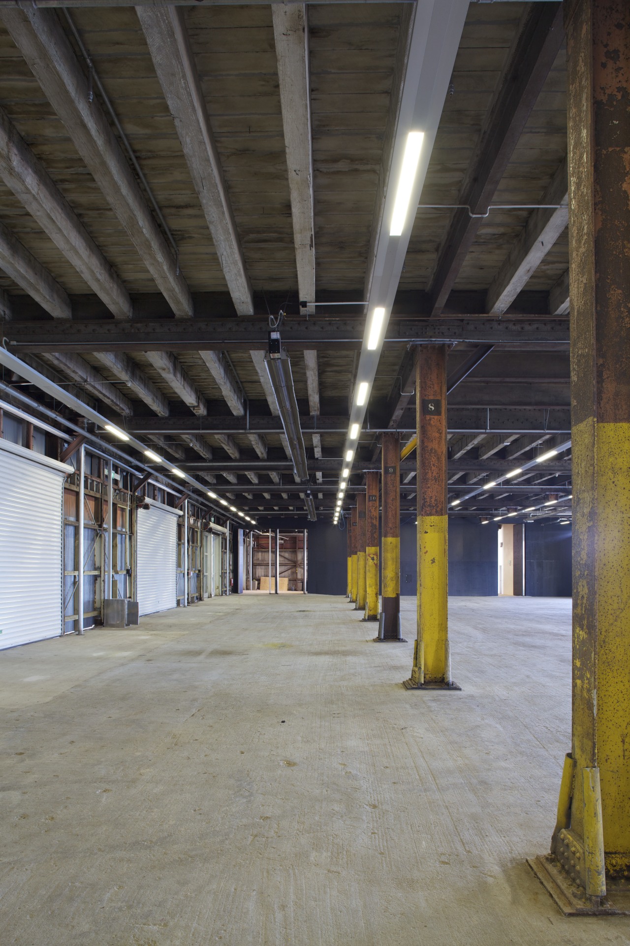 Macrennie Commercial Construction work on Shed 10 beam, ceiling, daylighting, structure, warehouse, gray, black