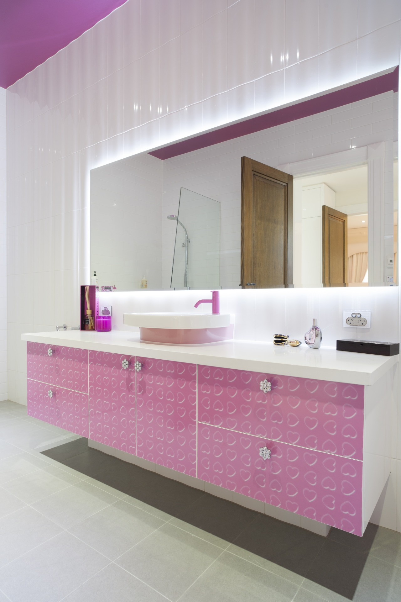 Girl's pink bathroom bathroom, bathroom cabinet, cabinetry, countertop, floor, flooring, interior design, kitchen, pink, product design, purple, room, sink, tile, wall, gray
