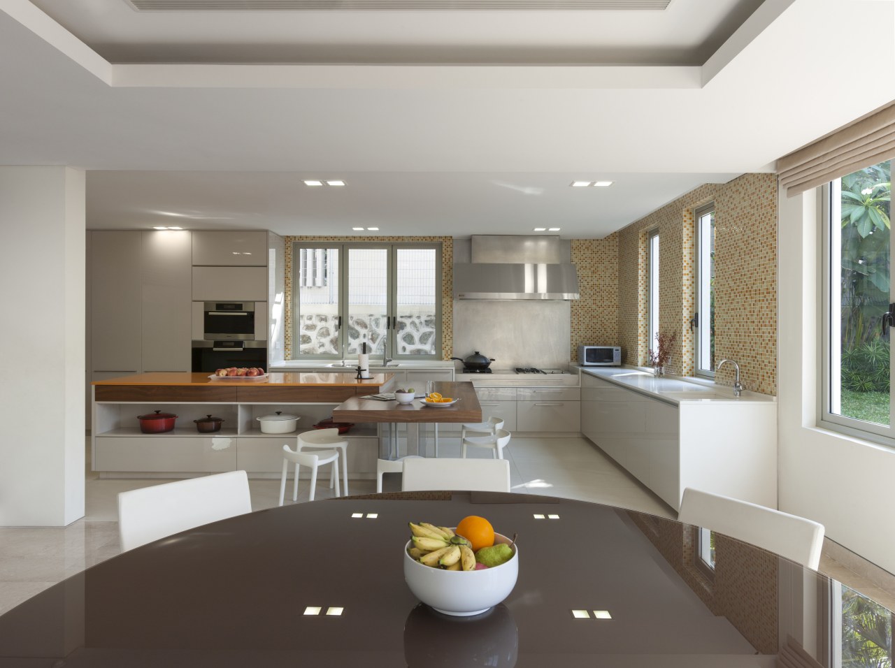 A large L-shaped island is the centrepiece of ceiling, countertop, interior design, kitchen, living room, real estate, gray