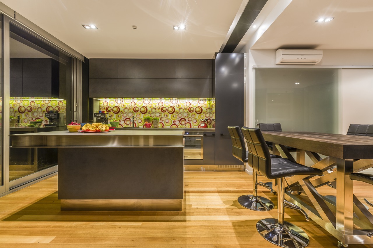 Mal Corboy kitchen with Smeg appliances.  Black countertop, flooring, interior design, kitchen, real estate, room, brown, orange