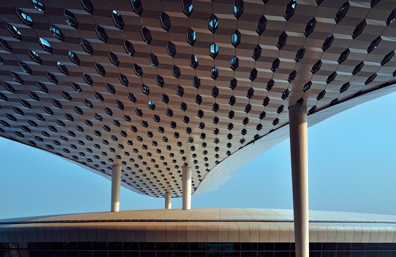 Looking much like a giant sculpture from both architecture, building, ceiling, daylighting, daytime, landmark, line, roof, sky, structure, symmetry, black