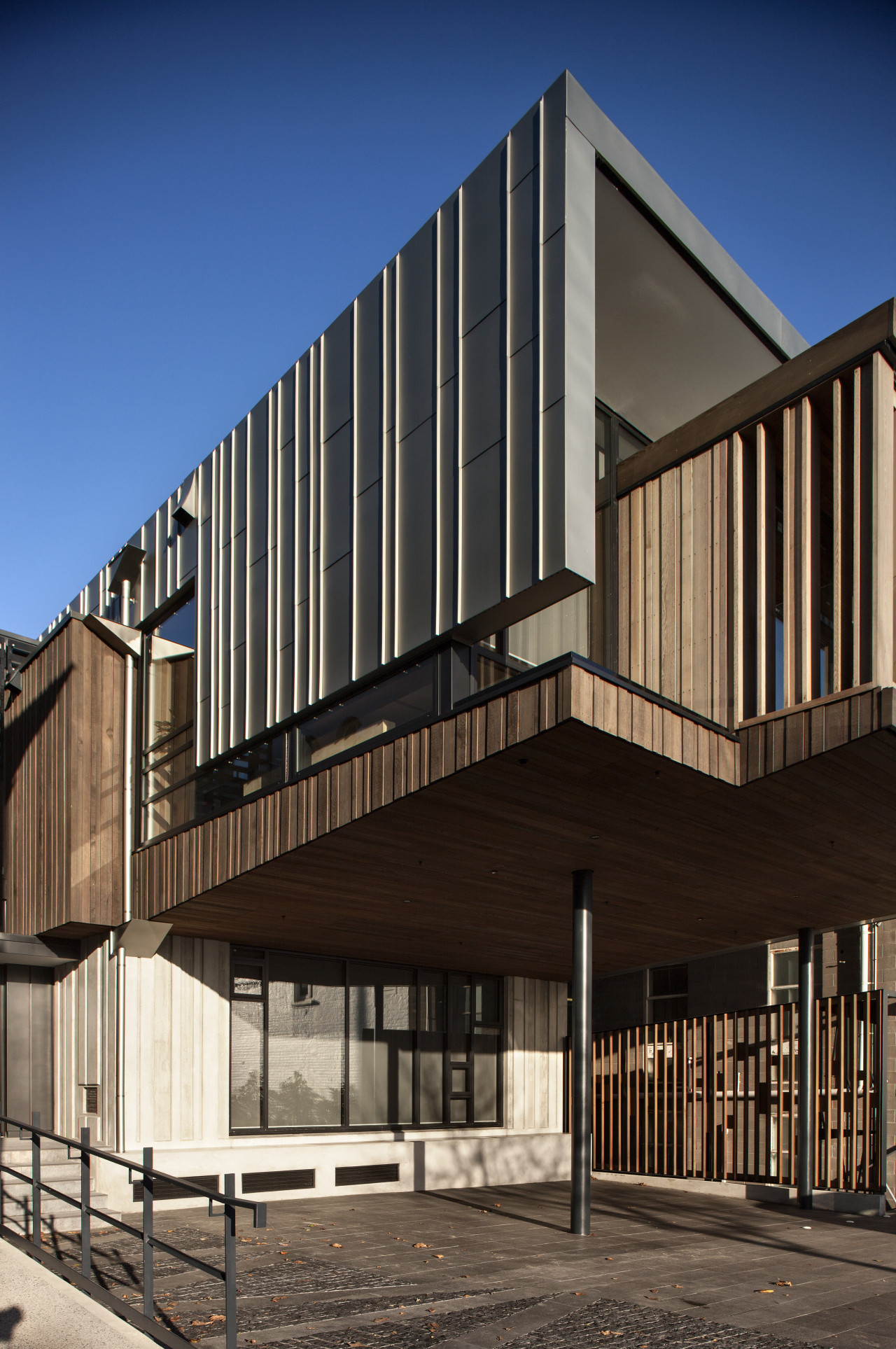 Titanium zinc cladding on modern building.  Titanium architecture, brutalist architecture, building, commercial building, corporate headquarters, facade, home, house, mixed use, residential area, siding, black